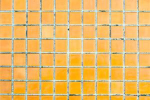 Texture of yellow mosaic tiles, close-up photo