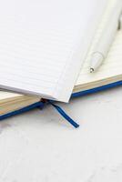 The pen lies in the notebook, the concept of study, time management. photo