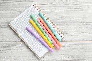 Notebook diary for planning and studying on the table with colored markers. photo