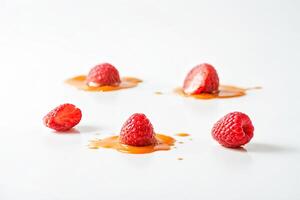 Raspberry and Caramel Sauce Drizzle on White Background photo
