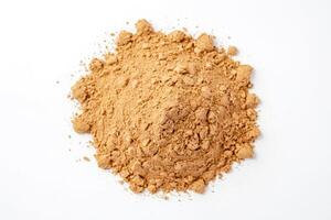 Closeup of a pile of brown powder on a white background photo