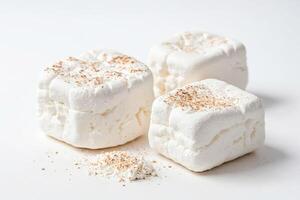 Three Marshmallows with Coconut Flakes on White Background photo