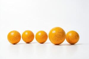 Five oranges arranged in a row against a white background photo