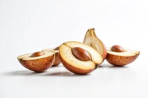 Close up of cut open shea nuts on white background photo