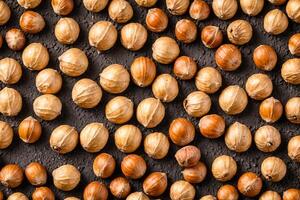 Hazelnuts Scattered On A Dark Background photo
