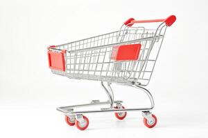 Empty shopping cart with red handles on a white background photo