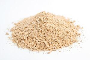 Close up of dried ginger powder on white background photo