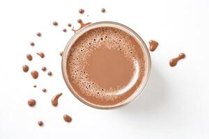 Top view of a glass of chocolate milk with splashes photo