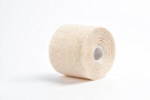 Roll of Beige Elastic Bandage on White Background photo