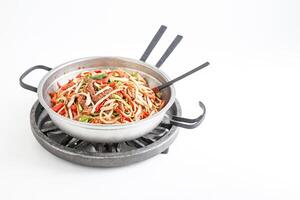 Stir-fried Noodles and Meat in a Wok on a White Background photo