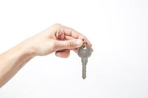 Hand Holding Key on White Background photo