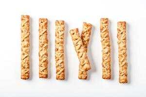 Sesame Seed and Peanut Bread Sticks on White Background photo