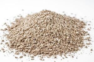 Pile of Brown Crushed Material on a White Surface photo
