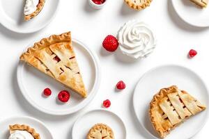 Flat lay of raspberry pie and whipped cream on white background photo