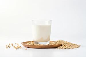 Soy Milk in Glass with Soybeans on Wooden Plate photo