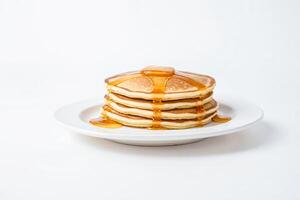 Stack of Pancakes with Honey Drizzle on White Background photo