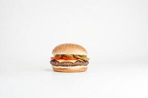 Cheeseburger with Pickles and Tomatoes on a White Background photo