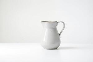 White ceramic pitcher on white background photo