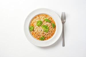 A simple bowl of noodles with a side of fork photo