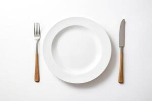White Plate with Fork and Knife on White Background photo