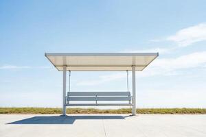 Minimalist white bench with a roof on a concrete platform photo