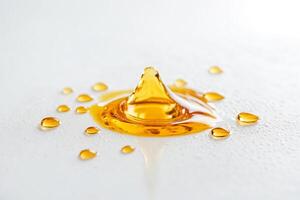Golden Liquid Drop Splashing on White Background photo