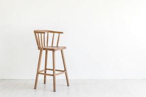 Wooden Bar Stool in Front of White Wall photo