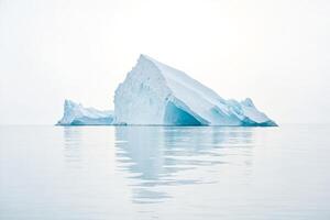 Majestic Iceberg Floating in Calm Waters photo