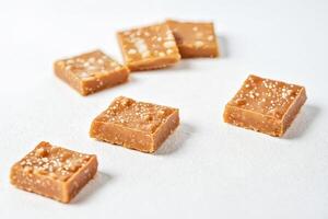Closeup of Salted Caramel Squares on White Background photo