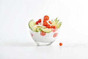 Bowl of Fresh Salad with Cherry Tomatoes, Cucumber, and Onion photo