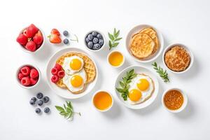 Breakfast with waffles, eggs, berries, and honey photo