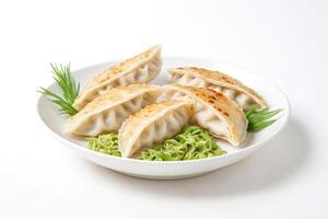 Close-up of Fried Dumplings with Green Garnish on a White Plate photo