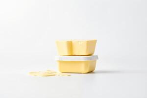 Butter Container with Spilled Butter on White Background photo