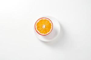 A Single Half of a Juicy Orange on a White Plate photo