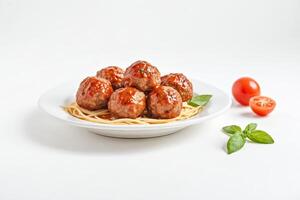 Meatballs with spaghetti and tomato sauce on white background photo