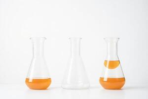 Three Erlenmeyer Flasks with Orange Liquid photo