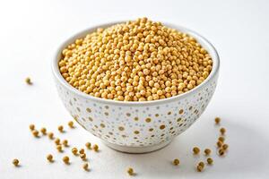 Close-up of Yellow Mustard Seeds in a White Bowl photo
