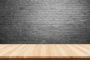 Empty Wooden Table on Blurred Brick Wall Background photo