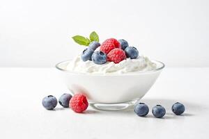 Bowl of Yogurt with Blueberries and Raspberries photo