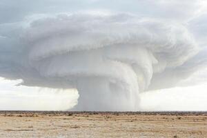 Massive Storm Clouds Forming Over Dry Desert photo