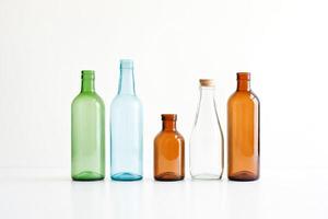 Five Empty Glass Bottles on a White Background photo