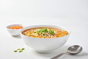 Bowl of Noodle Soup with Bean Sprouts and Green Onion Garnish photo