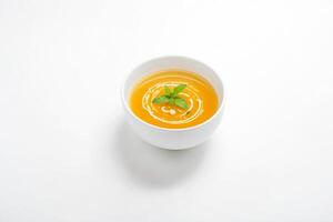 Bowl of Soup with a Single Leaf of Basil photo