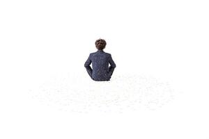 Man Sitting in a Sea of White Petals photo