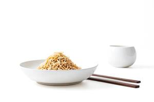 Bowl of Noodles with Chopsticks on White Background photo