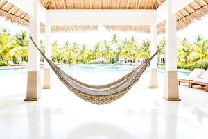 Hammock in front of a pool in a tropical resort photo