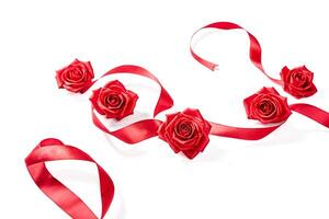 Red roses and ribbon on white background photo