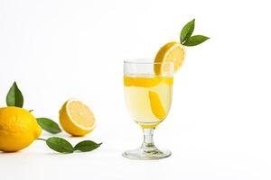 Glass of Lemonade with Lemon Slices and Leaves photo