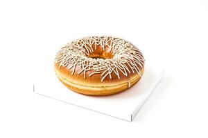 Glazed Donut with White Drizzle on White Background photo