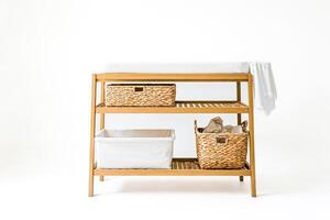 Wooden Changing Table with Wicker Baskets and White Fabric photo